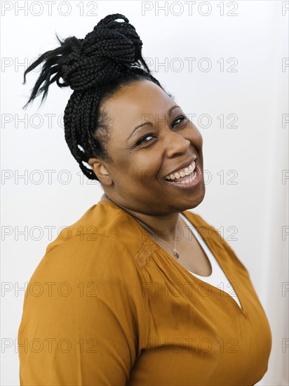 Portrait of smiling woman with black braided hair
