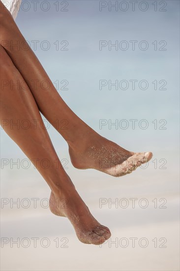 Woman's legs at tropical beach