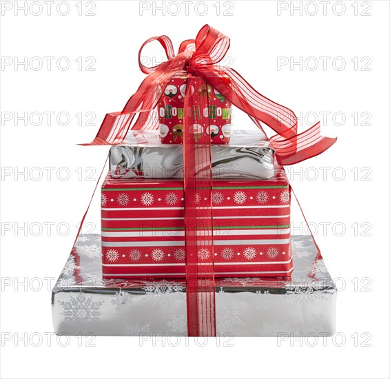 Studio shot of stack of Christmas gifts tide up with red ribbon