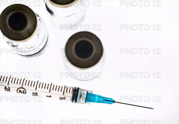 Studio shot of Covid-19 vaccine and syringe