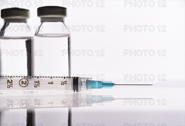 Studio shot of Covid-19 vaccine and syringe