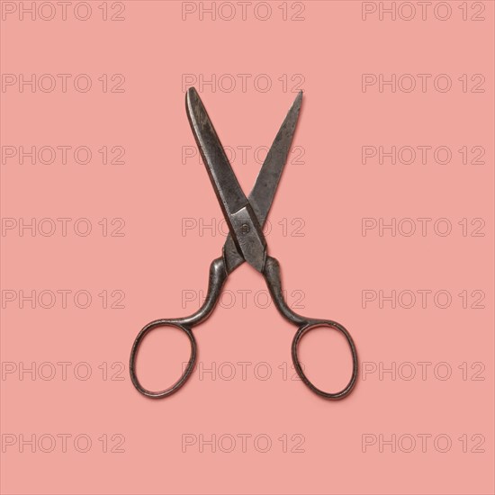 Studio shot of old fashioned scissors on pink background