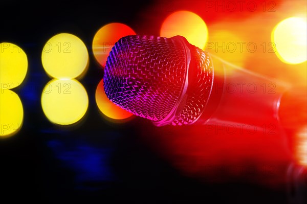 Close-up of microphone and stage lights