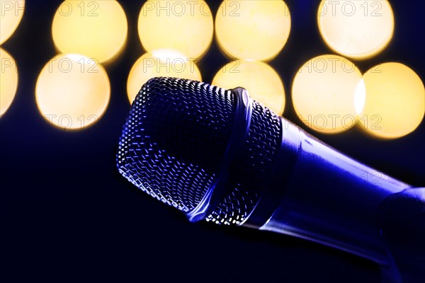 Close-up of microphone and stage lights