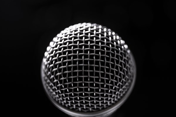 Close-up of microphone and stage lights