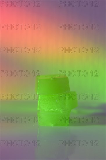 Stack of edible cannabis gummies in rainbow light