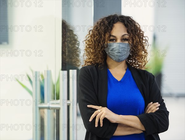 Portrait of businesswoman wearing face mask in office