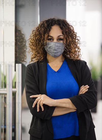 Portrait of businesswoman wearing face mask in office