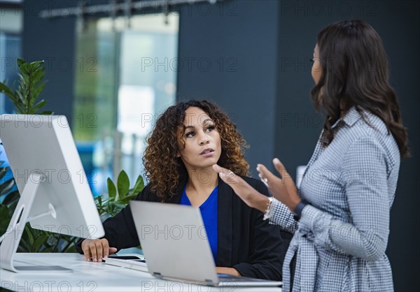 Two women talking in office