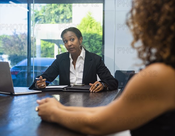 Two businesswomen at conference table