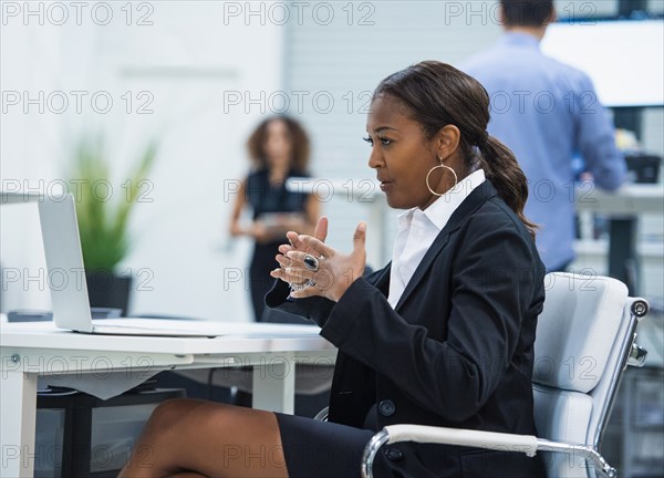 Businesswoman having video call via laptop in office