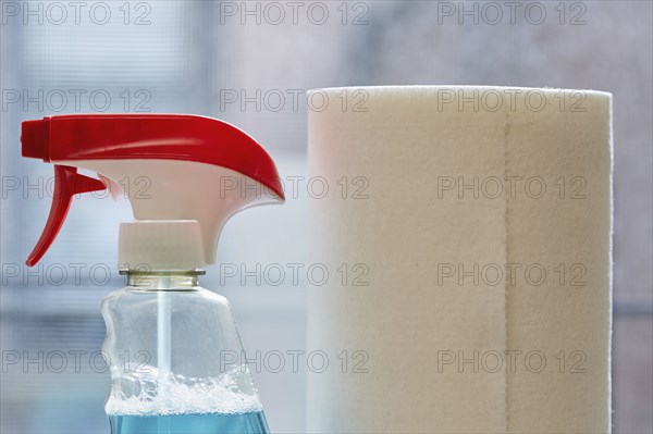 Close-up of spray bottle and paper towel