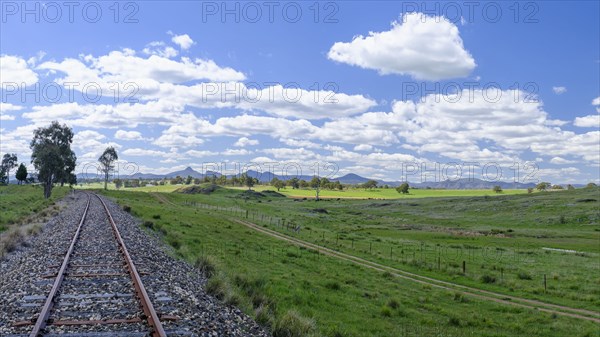 Railroad track under blue sky