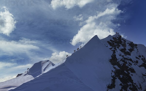 Climbers on mountain ridge at Monte Rosa Massif