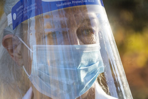 Portrait of senior female medical staff in covid protective clothing