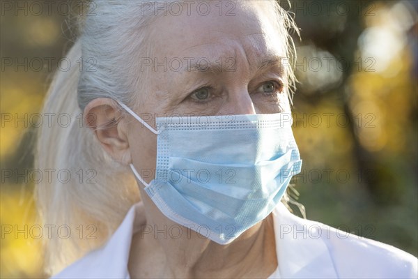 Portrait of senior female medical staff in covid protective mask