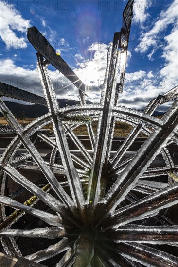 Frosted water wheel on ranch in morning sun