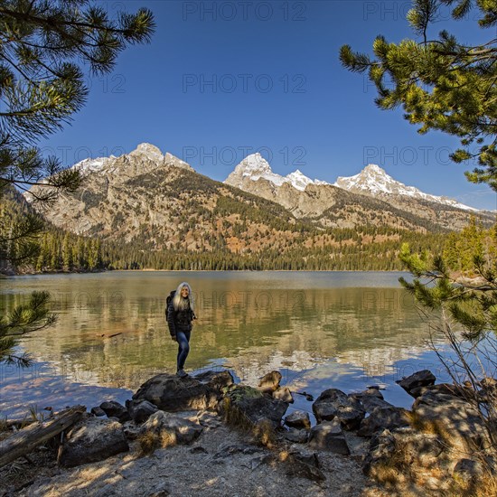 Senior woman standing by Taggart Lake in Grand Teton National Park