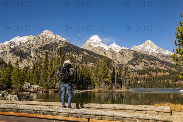 Senior woman standing by Taggart Lake in Grand Teton National Park