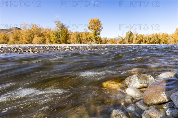 Motion blurred flow of Big Wood River in autumn