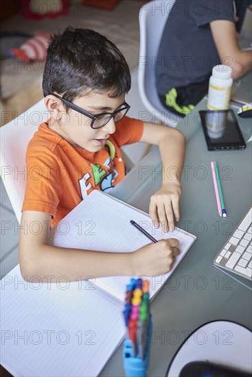 Two boys learning at desk at home during Covid-19 lockdown