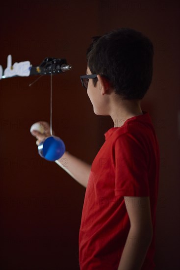 Boy (8-9) making presentation about sun phases at home school during lockdown