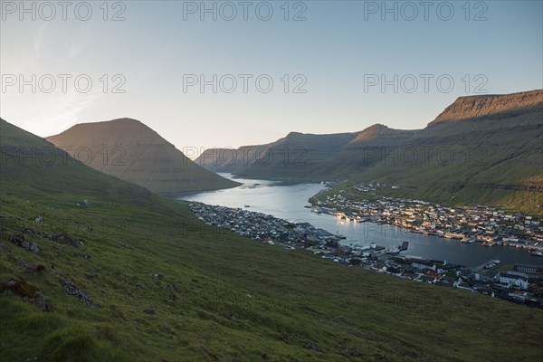 Landscape  with mountains and village by sea at dawn