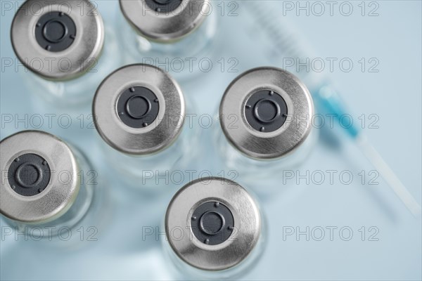 Overhead view of vials with Covid-19 vaccine and syringe