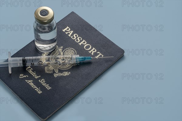 Covid-19 vaccine and syringe on US passport