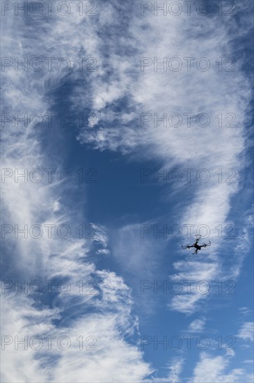 Low angle view of drone flying against sky