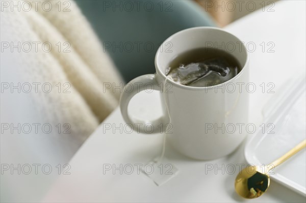 Mug with tea on table