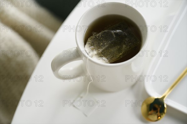 Mug with tea on table