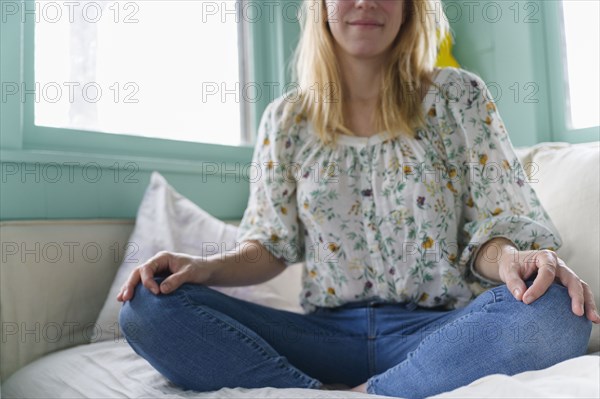 Woman sitting on bed