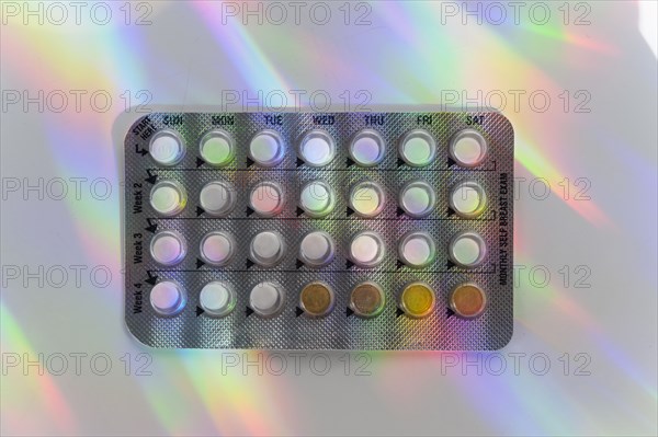 Birth control pills with colorful reflections