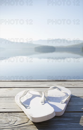 Pair of white sandals on dock