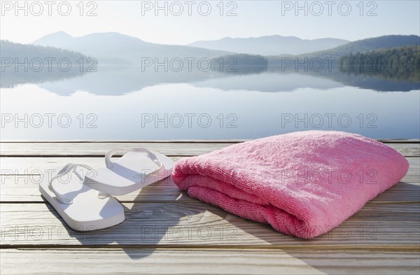 Sandals and towel on dock