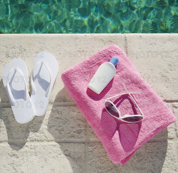 Sandals and towel at poolside