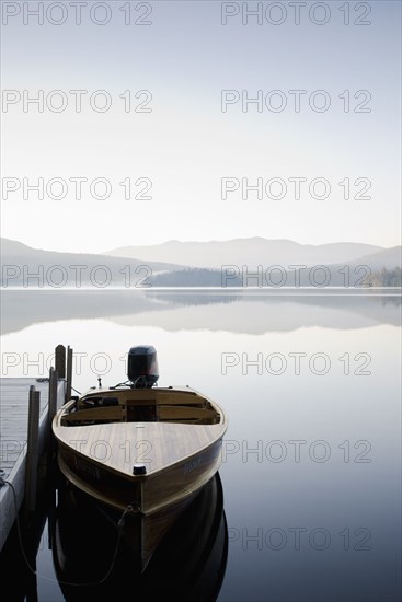 Motorboat docked on lake