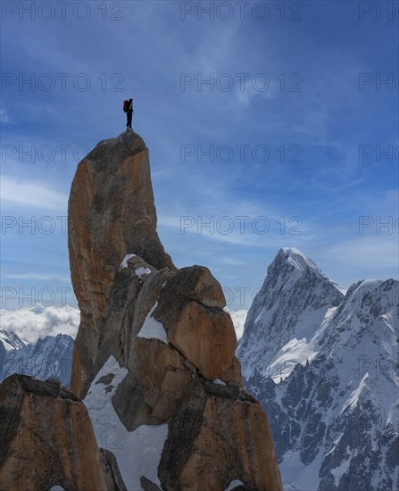 Chamonix, Climber standing on top of Aiguille du Midi in Mont Blanc Massif