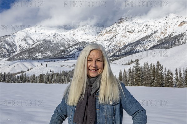 Winter portrait of senior woman in front of Boulder Mountains