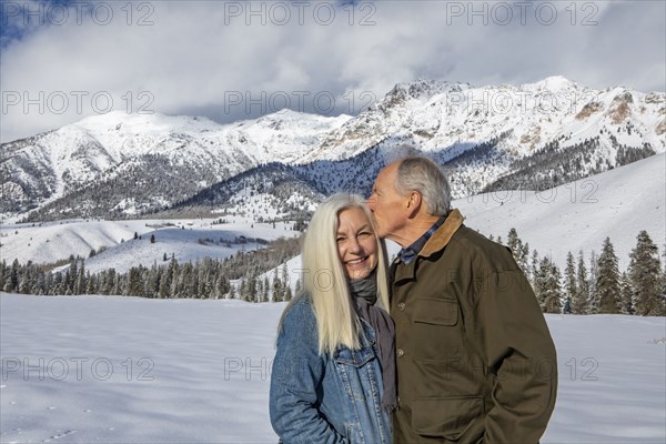 Winter portrait of senior couple in front of Boulder Mountains