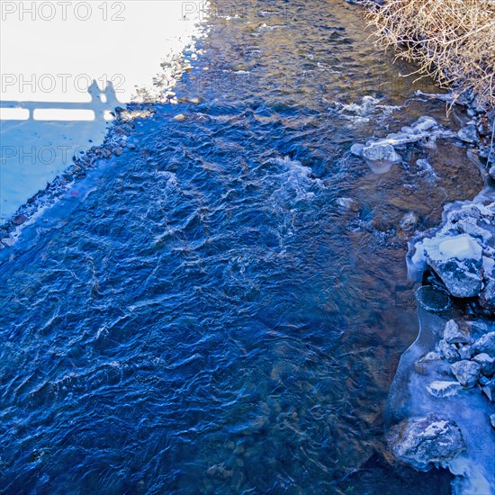 Shadows of onlookers on bridge over Big Wood River