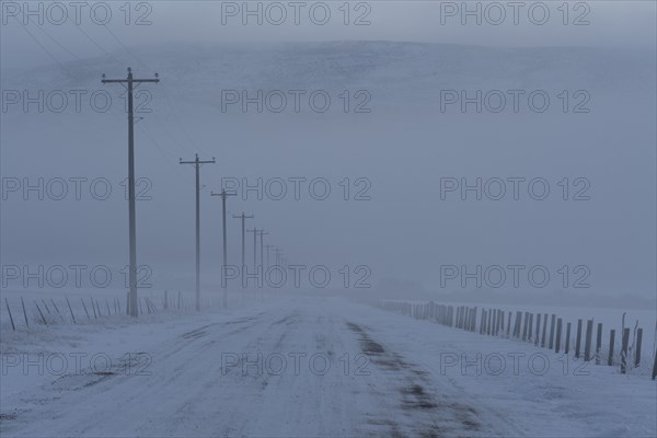 Empty frozen rural road in winter