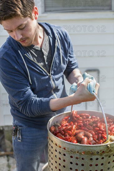 Caucasian man cooking crawfish outdoors