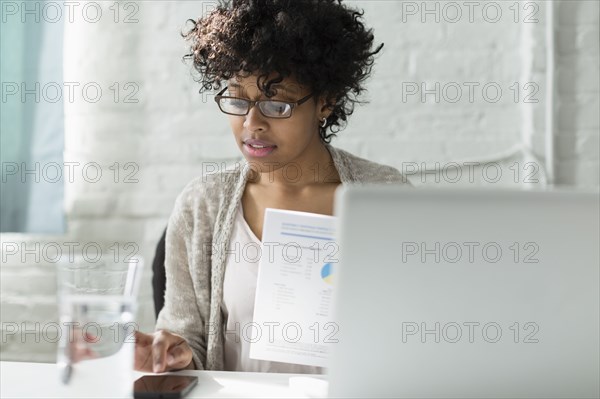 Mixed race architect working at desk