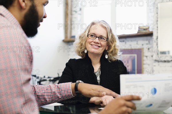 Businesswoman talking to young businessman