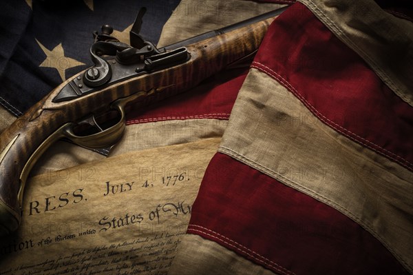 Flintlock pistol with American flag and Declaration of Independence