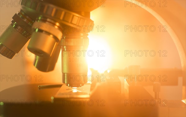 Close-up of microscope lenses with graphic light burst