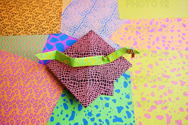 Origami snake on colorful origami papers