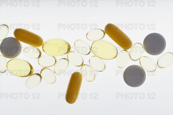 Pills and capsules on white background